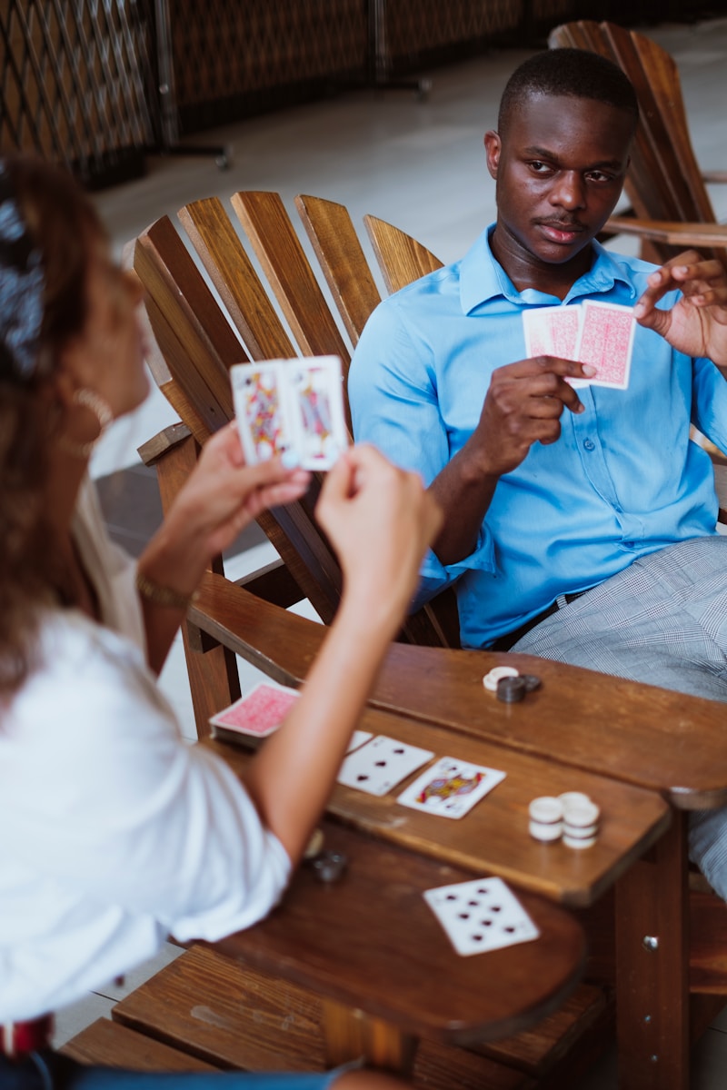 Pot odds in poker with man in blue button up shirt holding playing cards